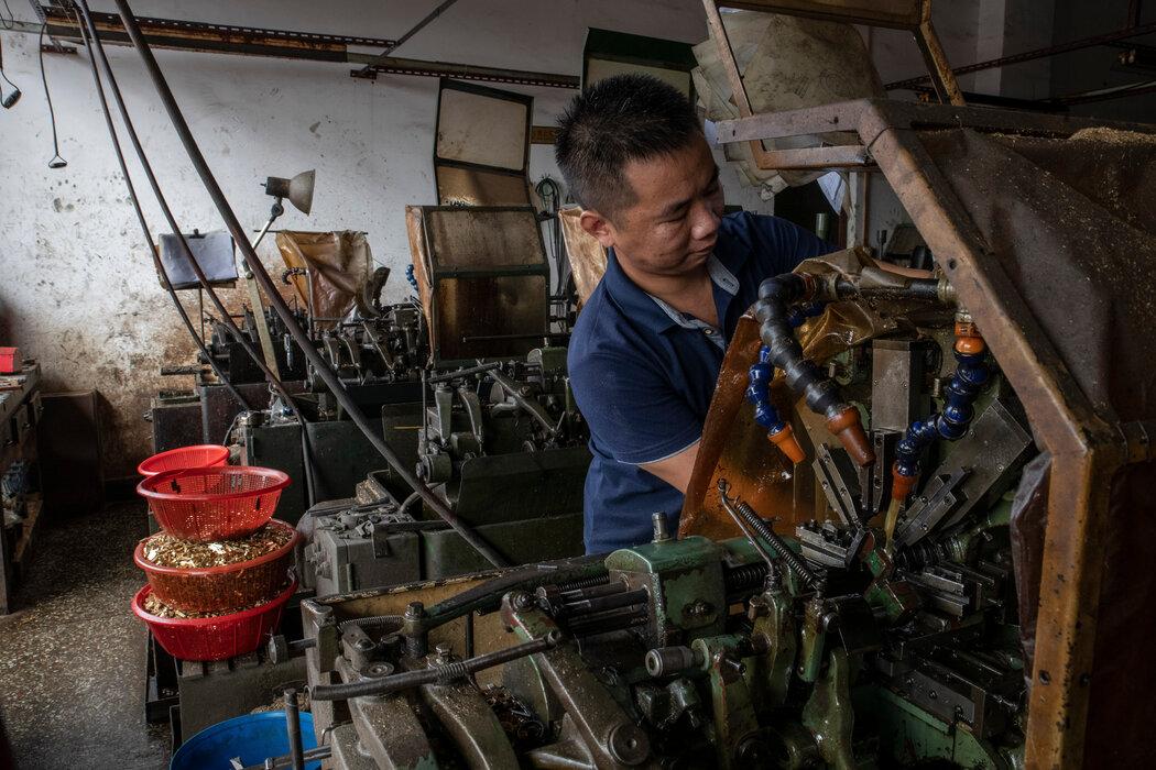 胡继彦（音）在他位于东莞的车间里制造小型机械零件